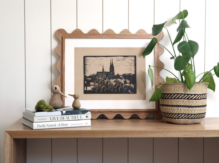 White oak 16x20 scalloped frame with a linocut print on a console table