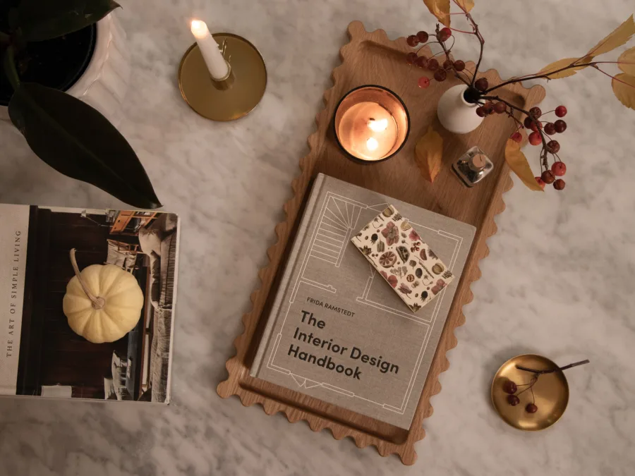 Scalloped oak tray styled with a book, lit candle and autumn berries