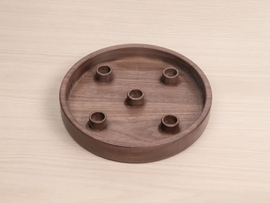 Round walnut advent candle holder with five candle holes, overhead view