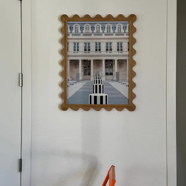 Customer photo of a large white oak Elise scallop frame on a wall