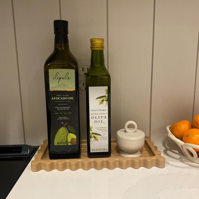 Customer photo of the white oak Sylvia scallop tray holding olive oil bottles